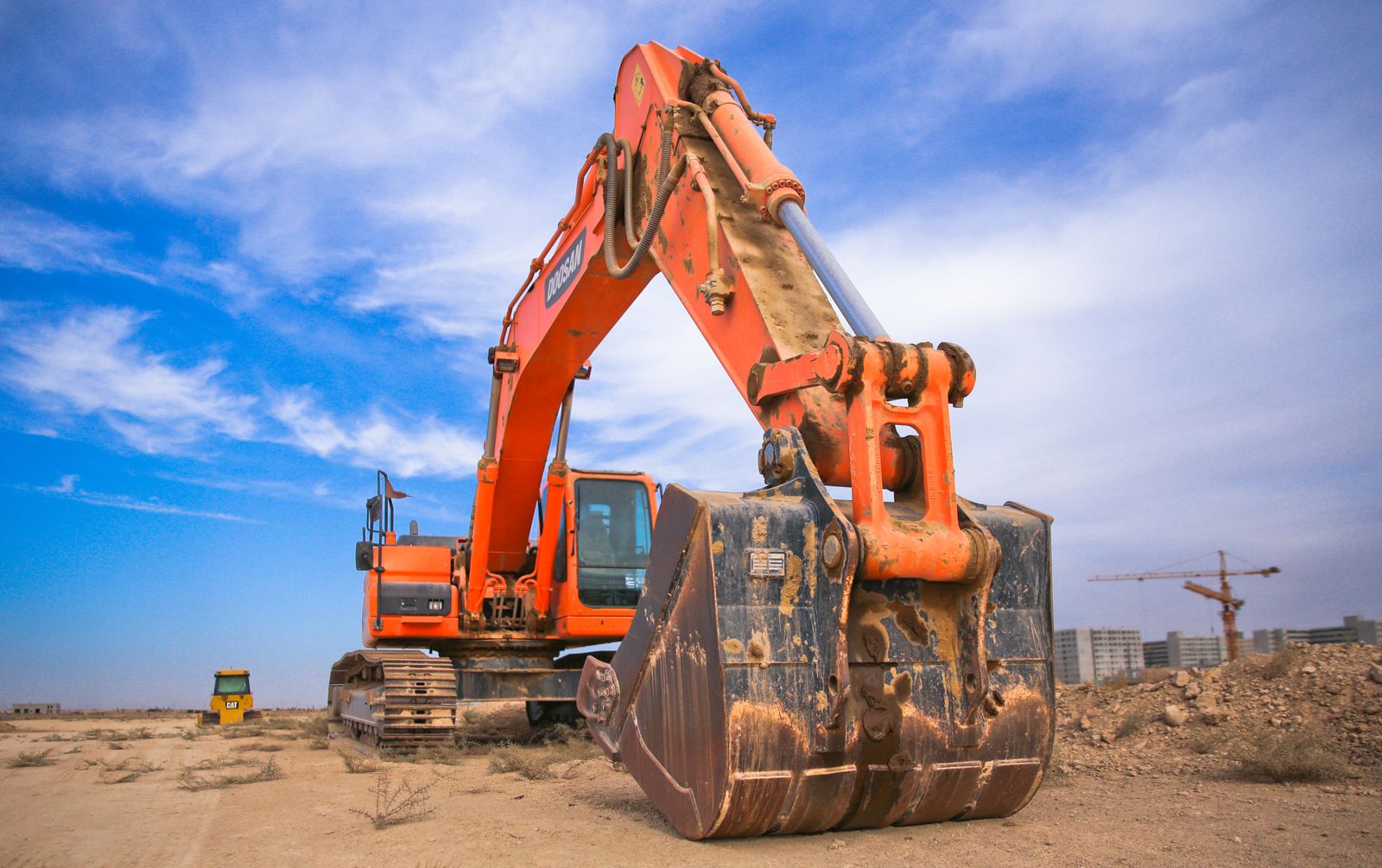 Orange excavator on an open dirt site prepared for earthwork